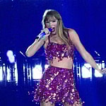 Taylor Swift holds a light saber style prop as bicycles and cars go by her in amazing visual show on stage during first weekend of her tour in Arizona