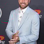 Travis Kelce smiling on the red carpet