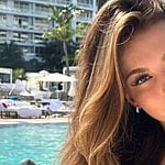 Grace Boor poses poolside in her pink bikini.