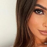 Eva Savagiou takes a selfie in her blue crop top.