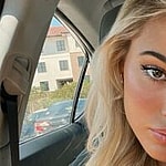 Olivia Dunne takes a selfie in the car.