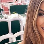 Chrishell Stause smiles at an outdoor table