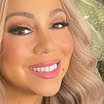 Mariah Carey poses smiling
