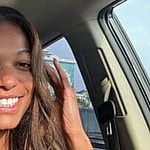 Gabby Thomas takes a selfie in the car