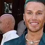 The Vivienne poses out of drag.