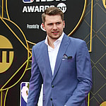 Luka Doncic smiling on the red carpet.