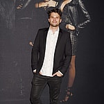 Tom Schwartz posing in a black jacket and white shirt