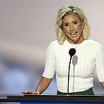 Savannah Chrisley speaking in front of a crowd of people at the RNC.