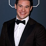 Adam DeVine posing on the red carpet.