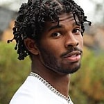 Shedeur Sanders posing in his yard.