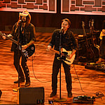 FIREROSE, Billy Ray Cyrus and Travis Denning performing on stage