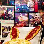 Hakki Akdeniz holding pizza