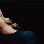 Karol G posing in black