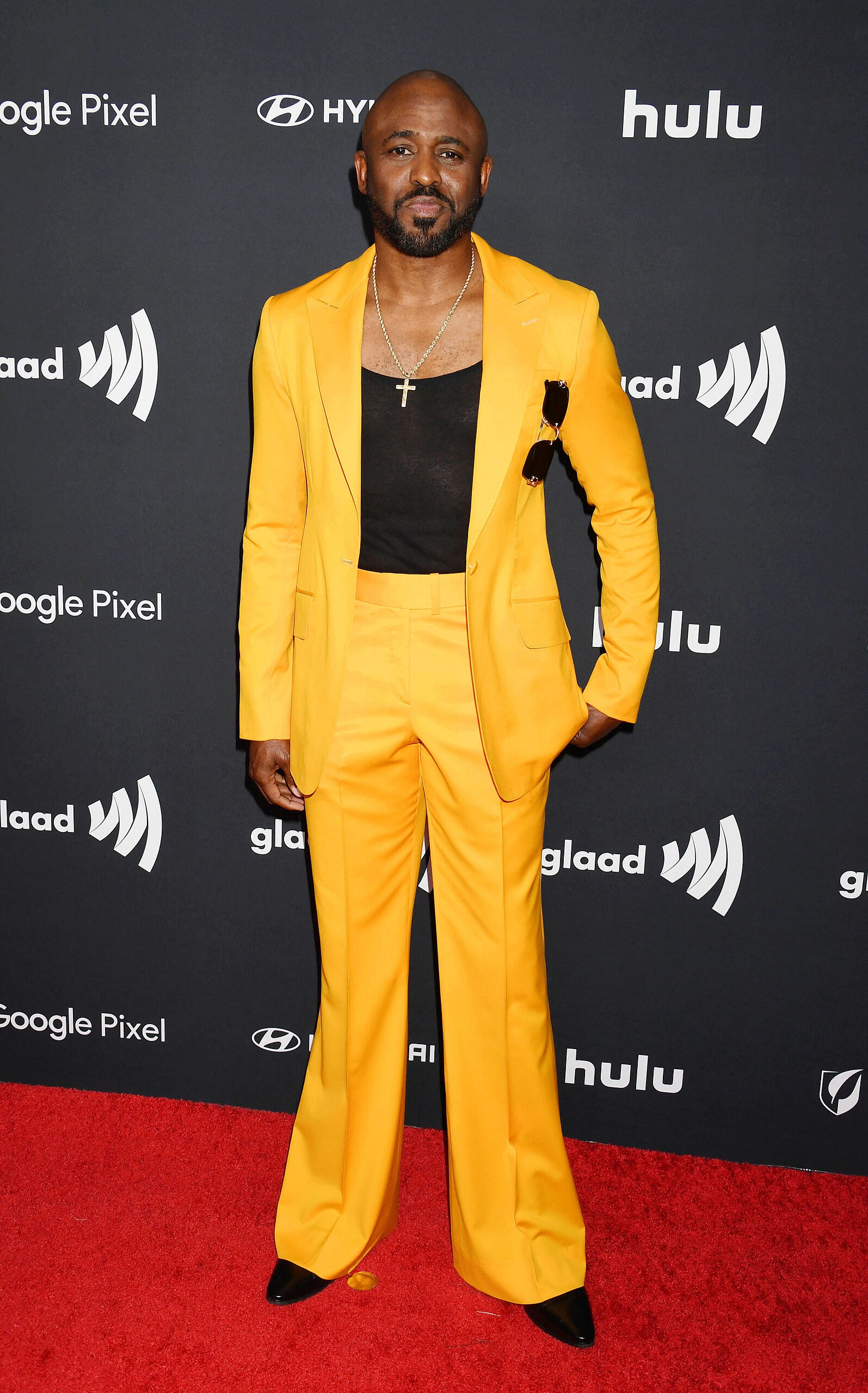 Wayne Brady posing on the red carpet. 
