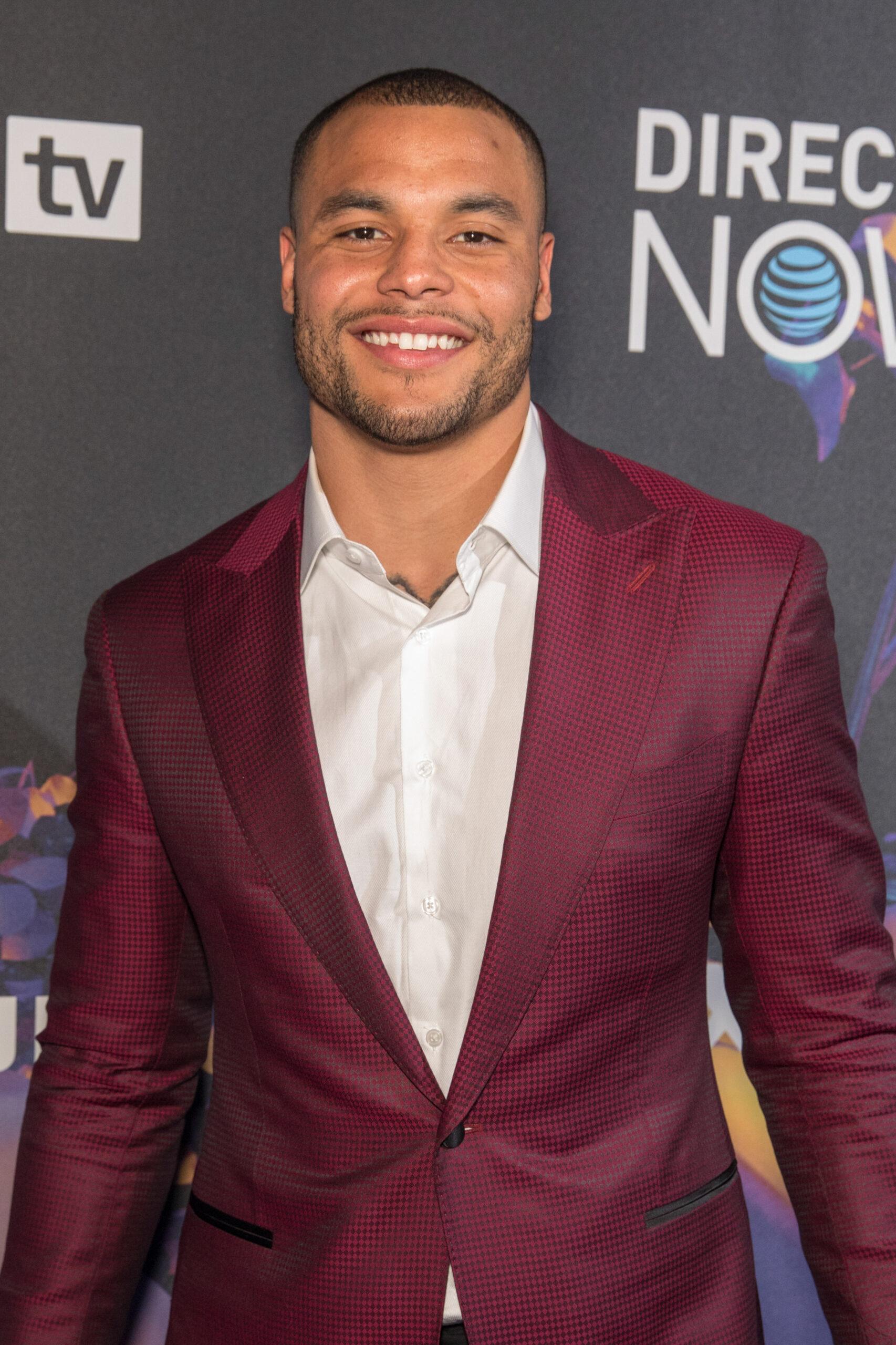Jalen Hurts at DIRECTV Now event in maroon blazer and white shirt