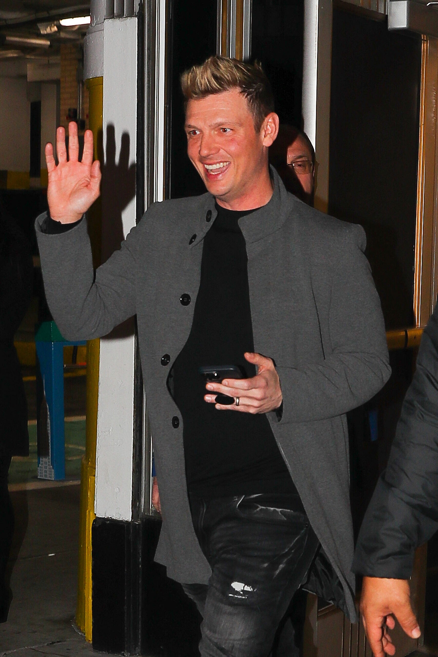 Nick Carter is all smiling on the day he was sued for Alleged Rape of 17-Year-Old Girl On Tour Bus, Nick waves at his fans outside the Empire State Building in New York City