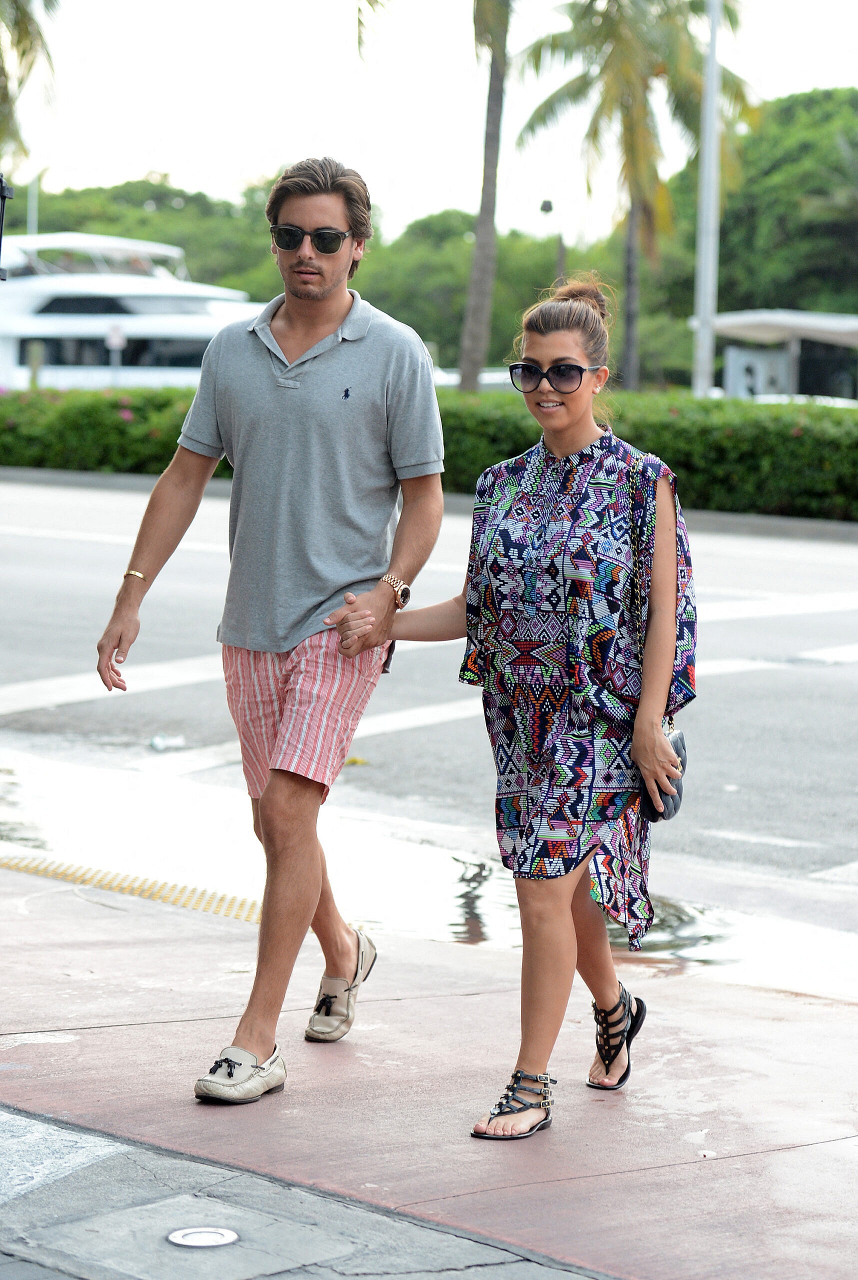 Reality TV stars Kourtney Kardashian and boyfriend Scott Disick take a ride on a red speed boat in Miami Beach