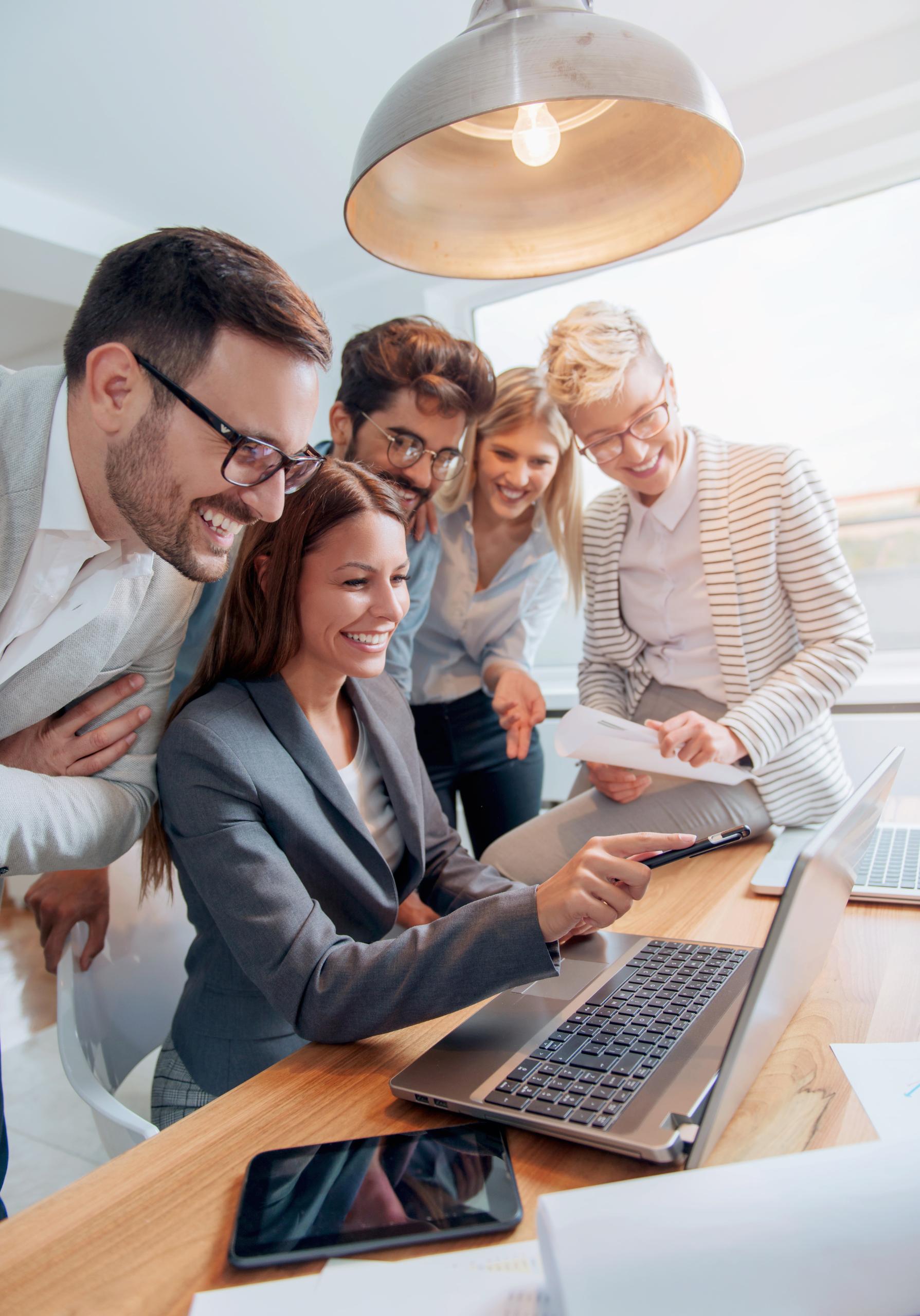 Group of people in front of computer looking happy