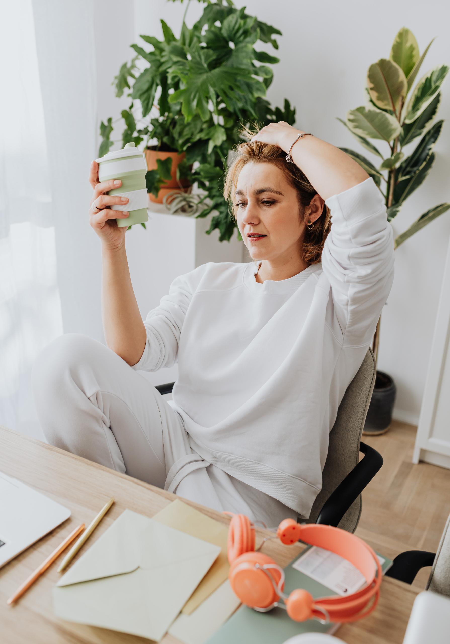 Woman at computer with hand on head