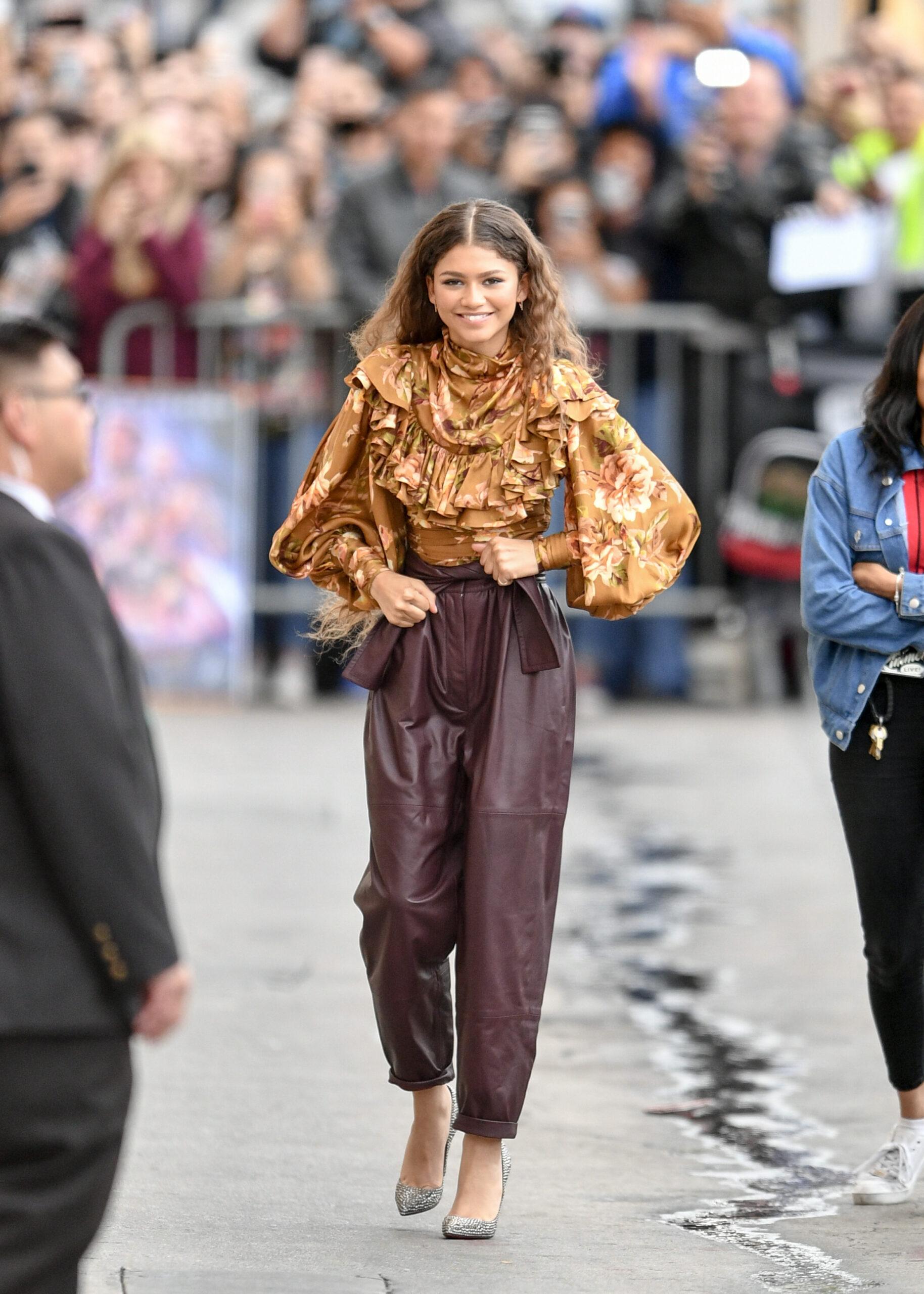 Zendaya Visits Kimmel in a brown pant and yellow blouse.