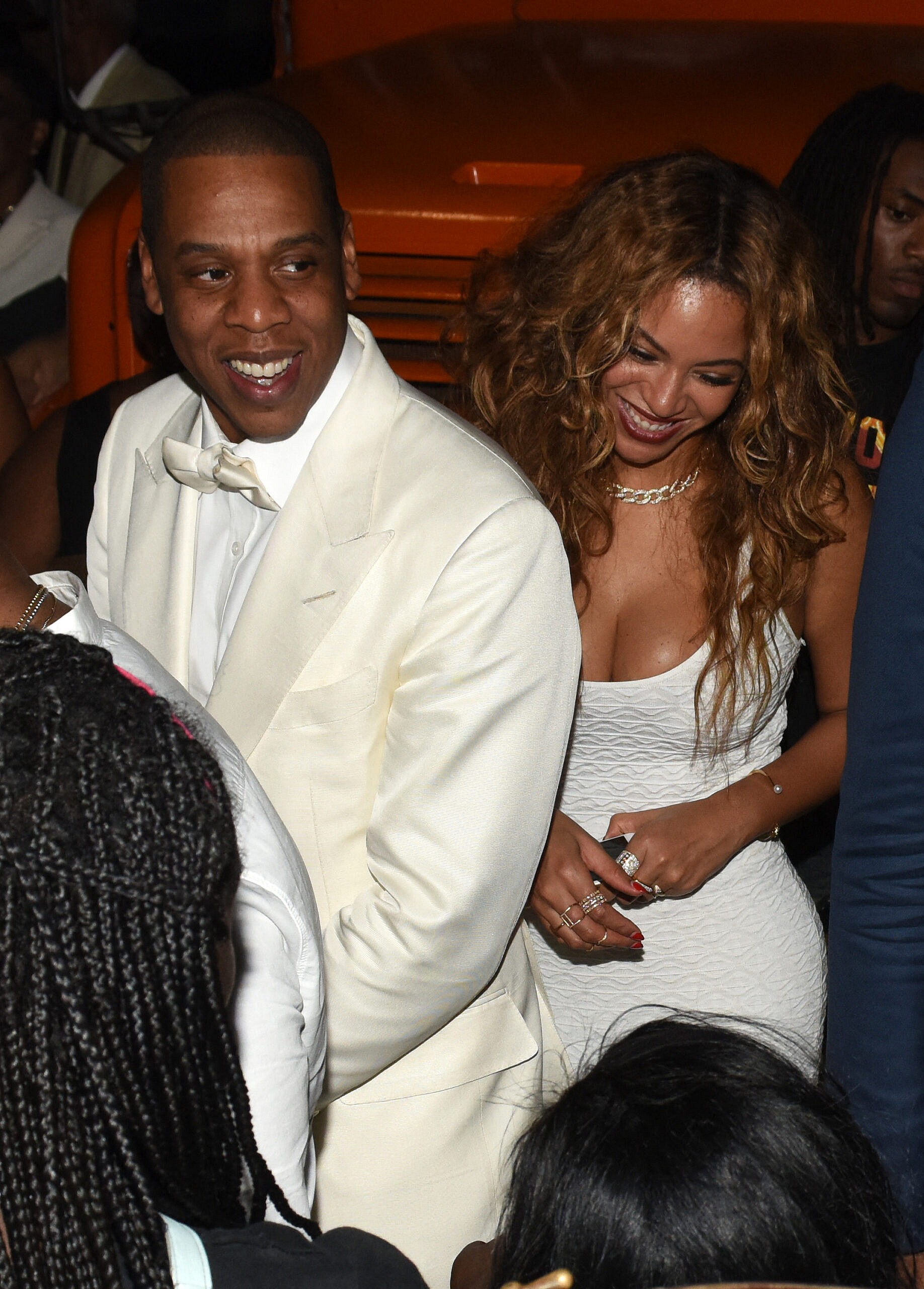 Beyoncé and Jay-Z laughing together during an event. 