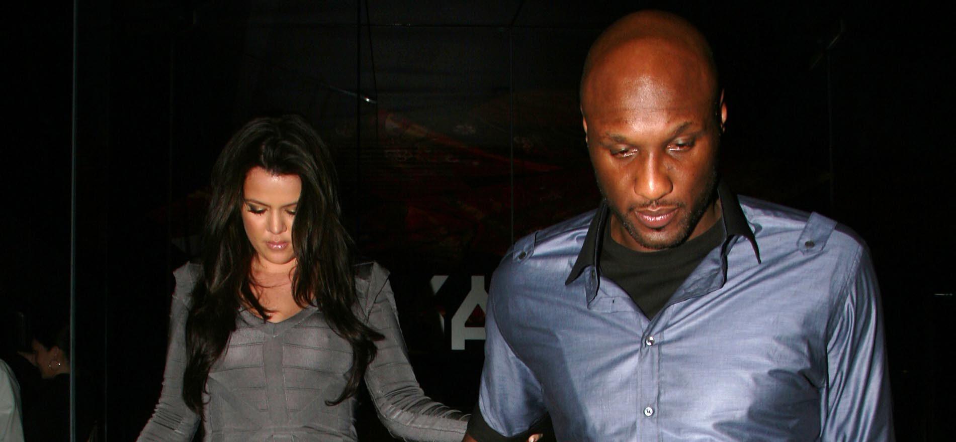 Lamar Odom and a woman walking together at night