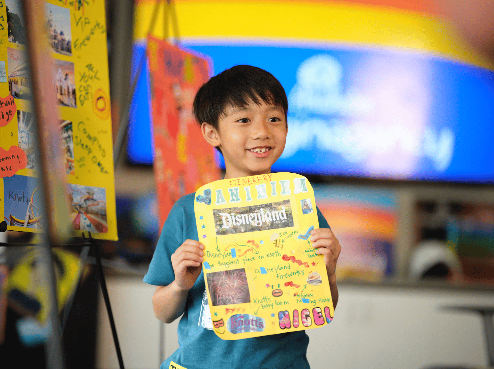 Kid holding up his Disney itinerary