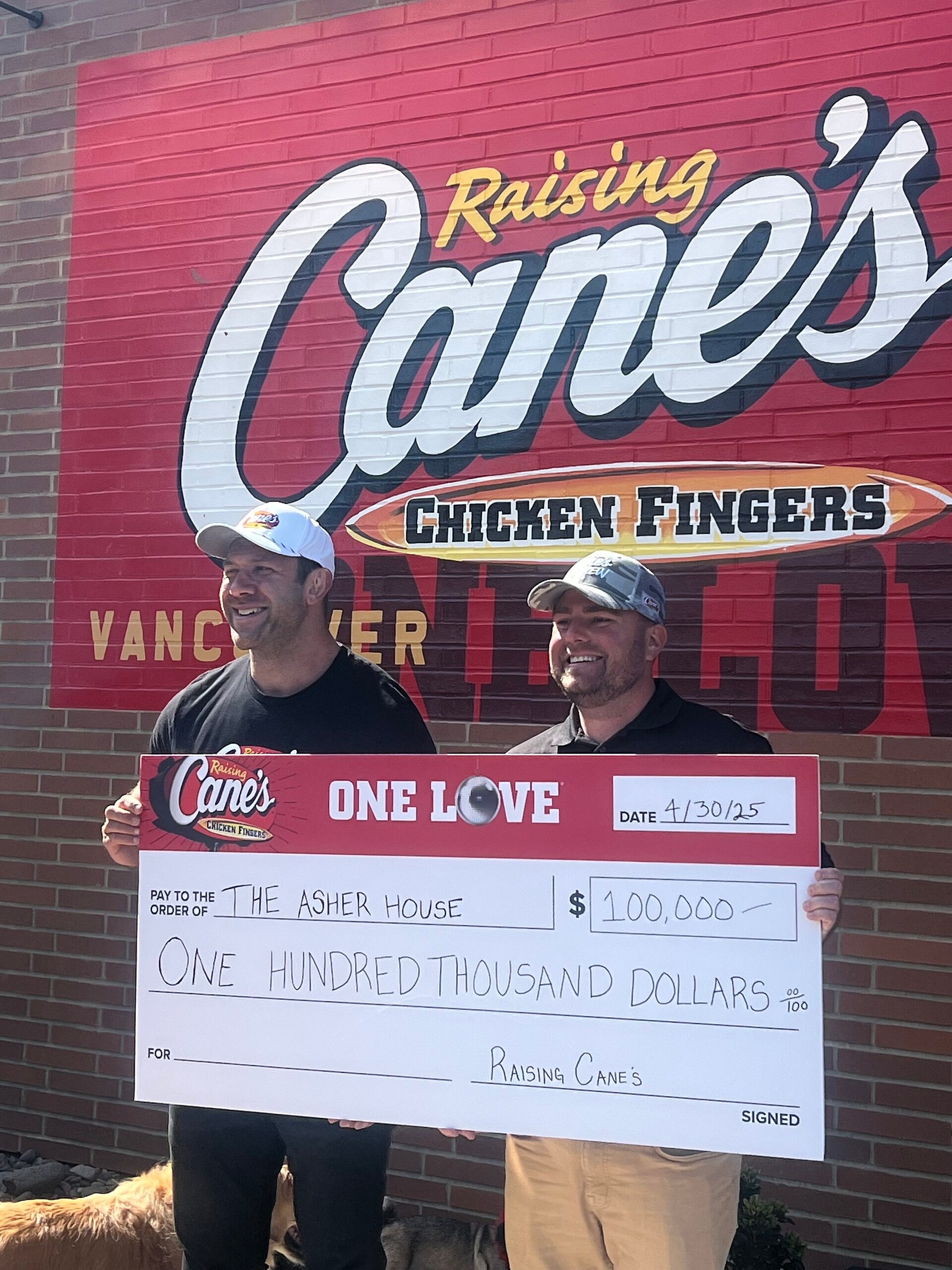 Lee Asher accepting check from Raising Cane's
