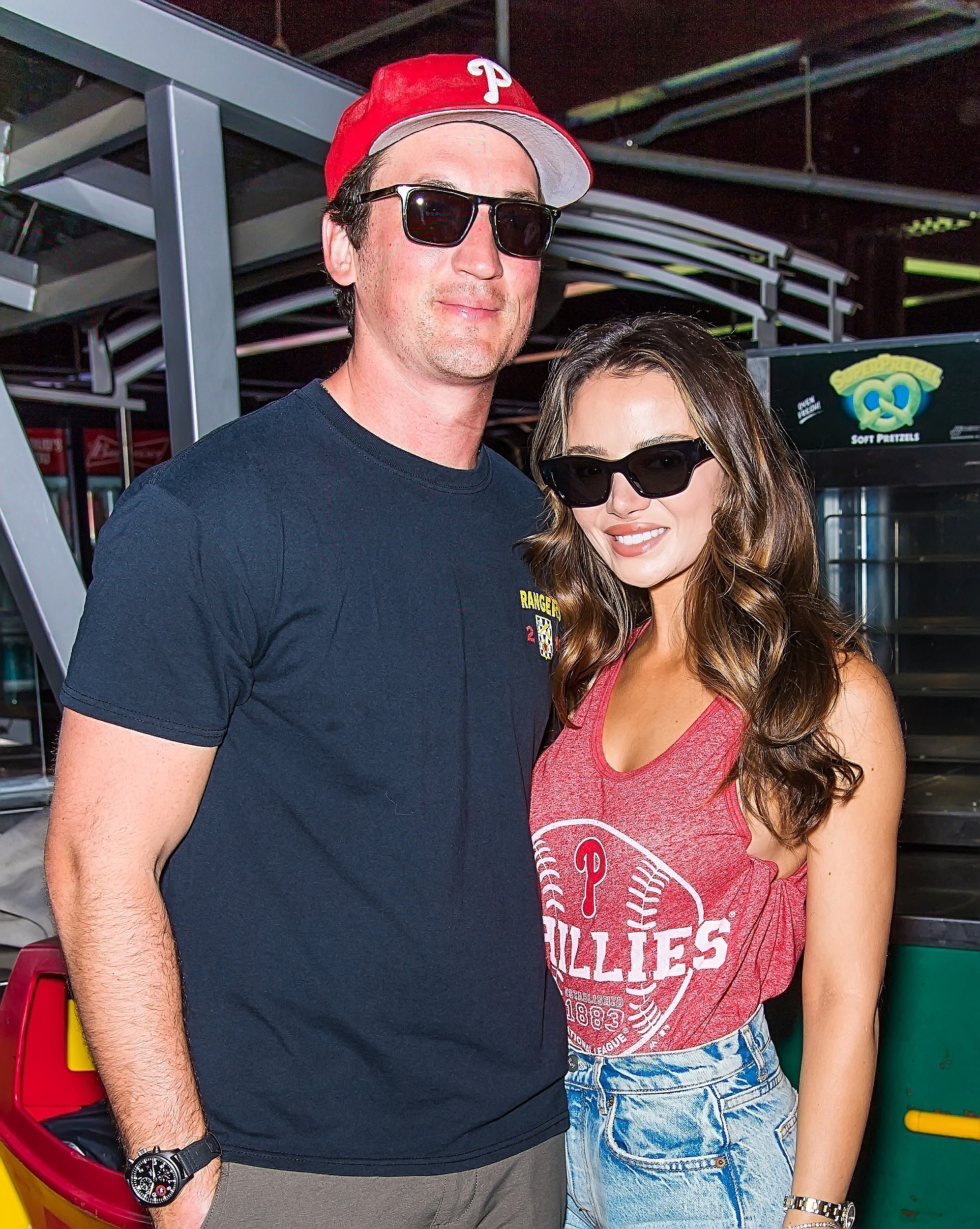 Miles Teller and Keleigh Sperry posing while wearing dark shades