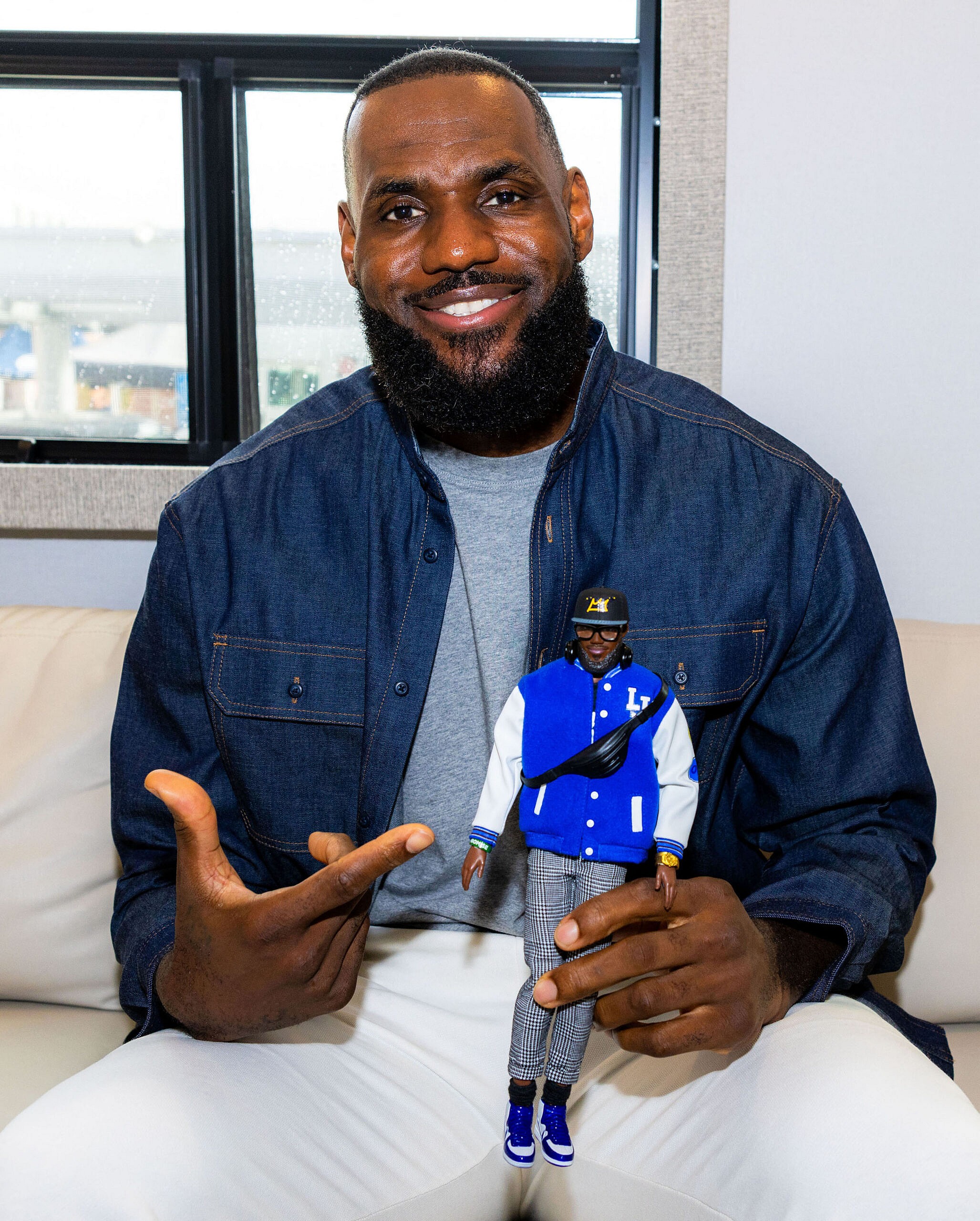 LeBron James posing with his Ken doll.