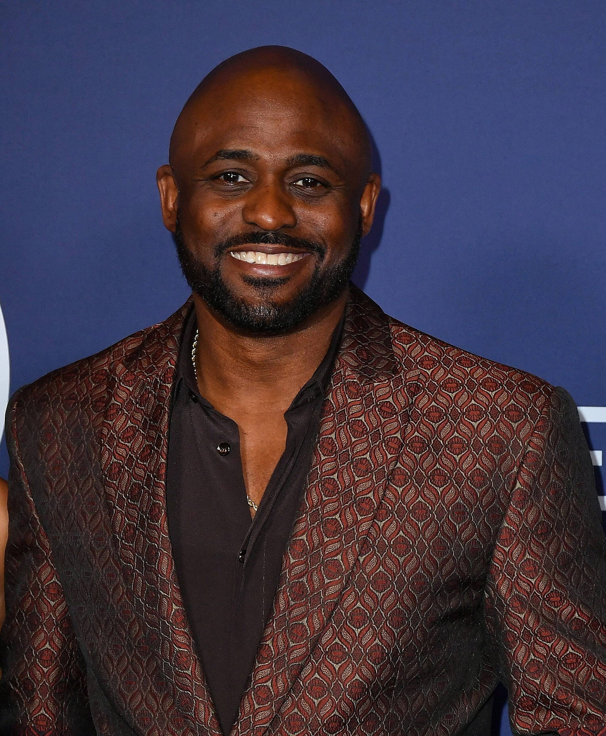 Wayne Brady posing on the red carpet. 