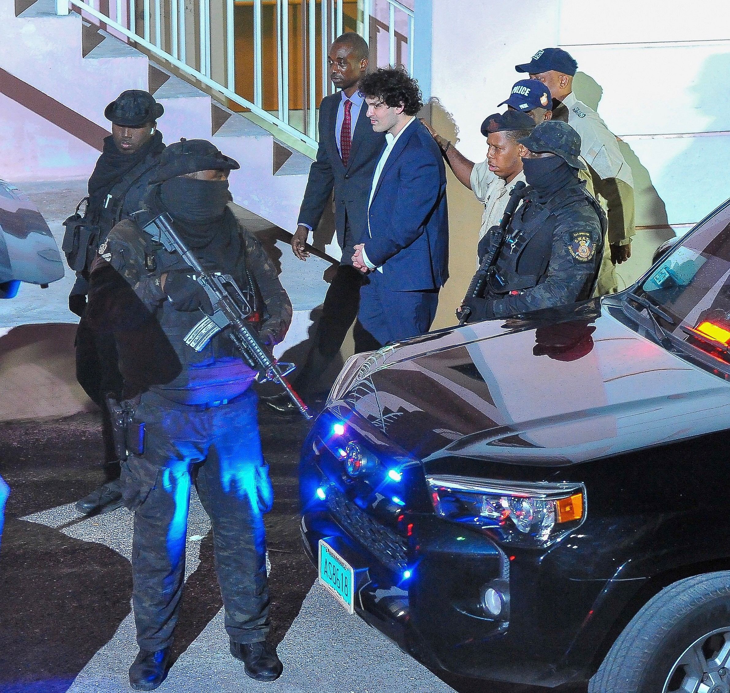 FTX founder Sam Bankman-Fried is seen in handcuffs as he leaves a court in the Bahamas after U S files criminal charges
