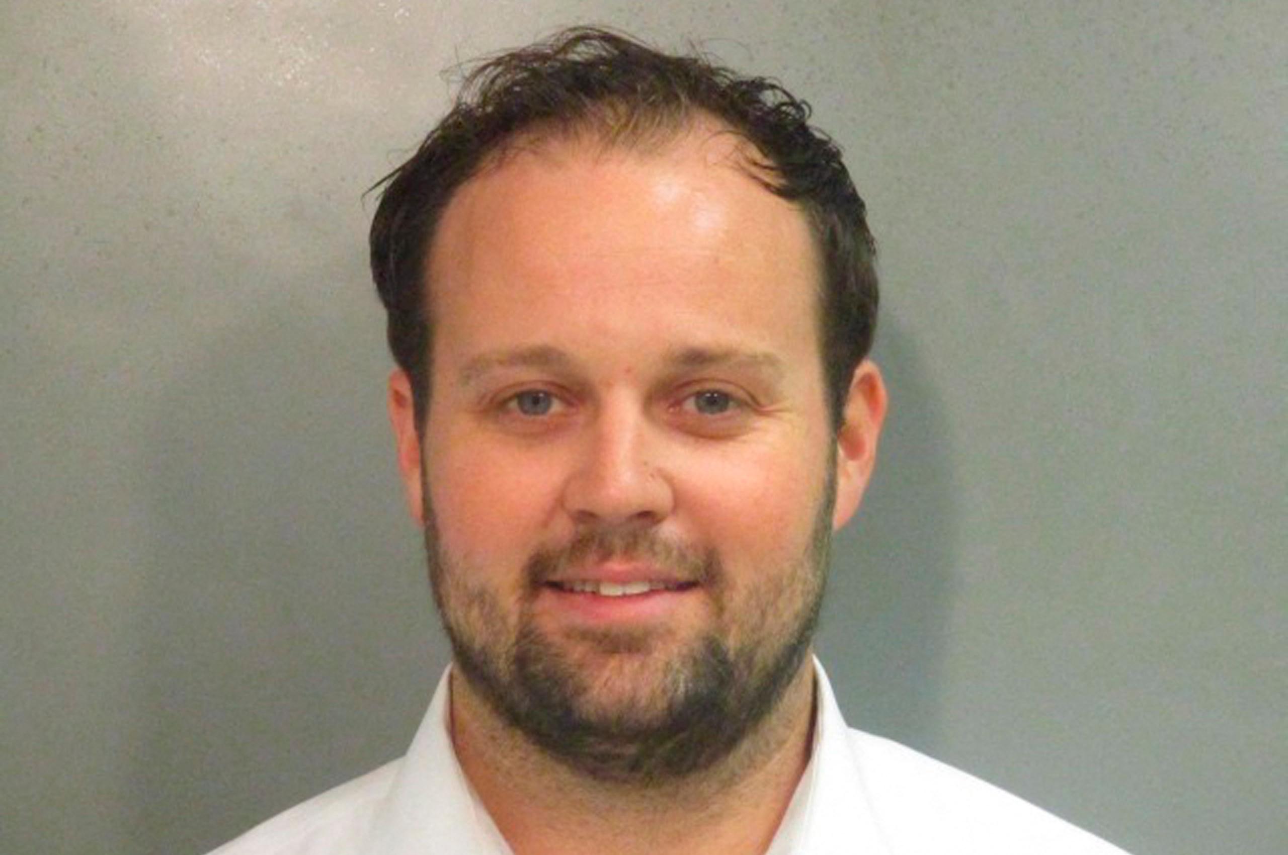 Josh Duggar smiles in new mugshot photograph after being found guilty in child pornography case