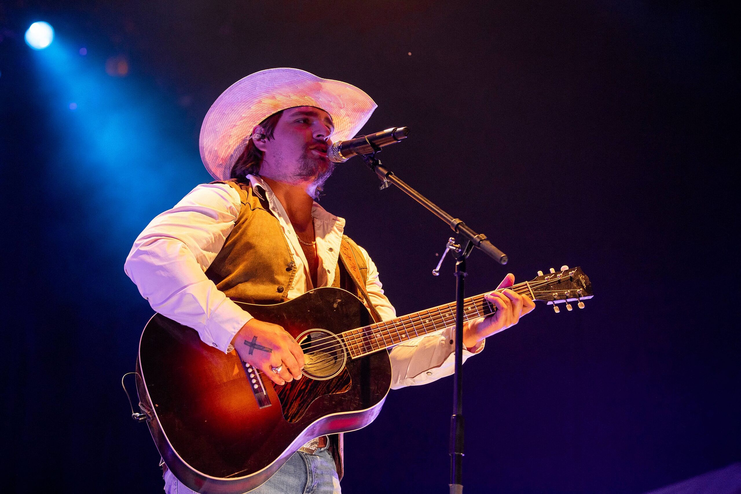 Gavin Adcock singing on a stage.