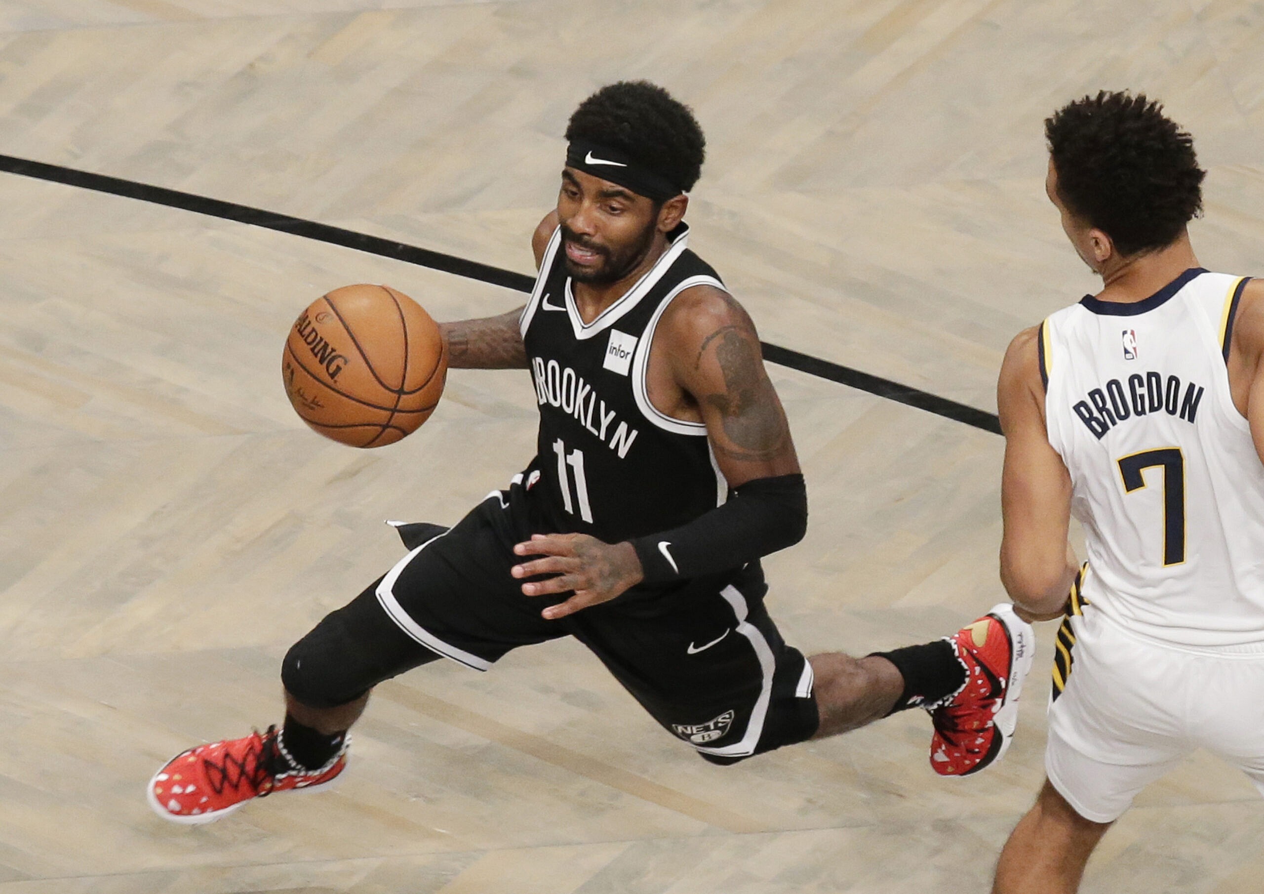Brooklyn Nets Kyrie Irving drives to the basket past Indiana Pacers Malcolm Brogdon in the first half at Barclays Center on Wednesday, October 30, 2019 in New York City.