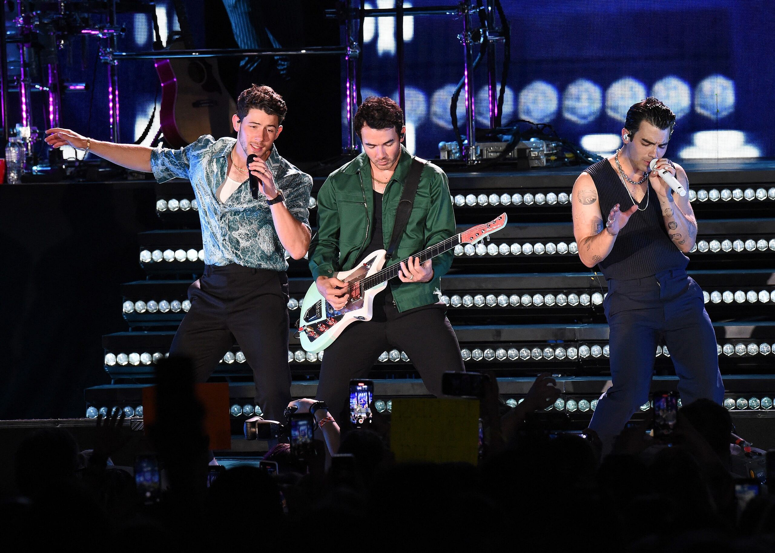 Nick, Kevin, and Joe Jonas on stage
