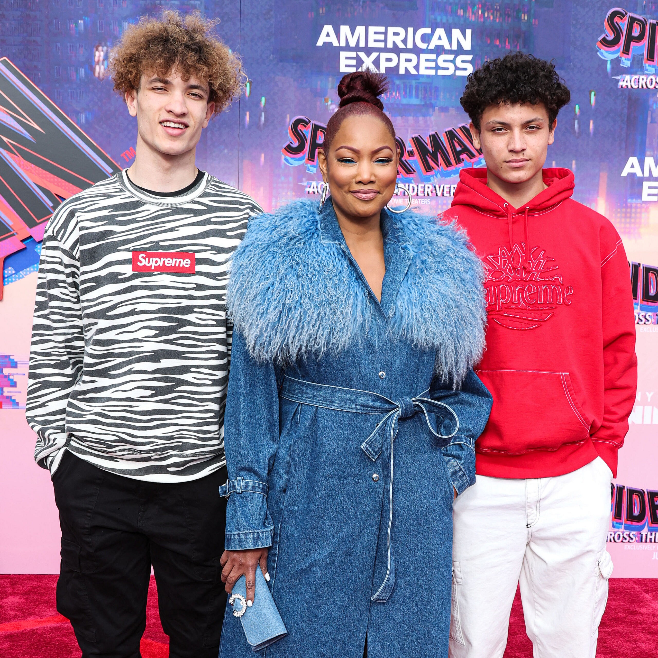 Garcelle Beauvais posing with her kids on the red carpet.