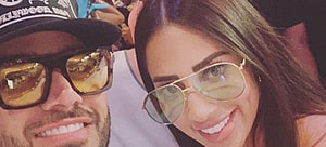 man and woman smiling for a photo