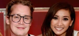 Macaulay Culkin and Brenda Song smiling.