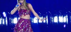 Taylor Swift holds a light saber style prop as bicycles and cars go by her in amazing visual show on stage during first weekend of her tour in Arizona