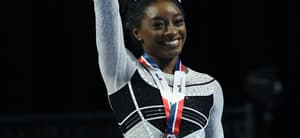 Simone Biles smiles as she takes home Olympic medal