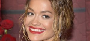 Rita Ora smiles at an event