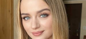 Joey King smiles indoors