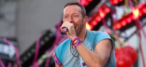 Vocalist Chris Martin along with his band Coldplay during a performance on a television show at Rockefeller Plaza in New York City