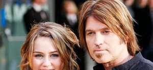 Miley Cyrus and Billy Ray Cyrus smiling