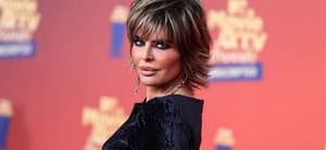 Lisa Rinna posing in a black dress during the MTV Movie Awards.