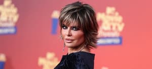 Lisa Rinna posing in a black dress during the MTV Movie Awards.