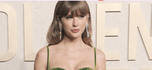 Taylor Swift posing in a green dress on the red carpet.