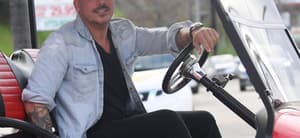 Jax Taylor looking into the camera on a golf cart.