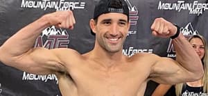 Ryan Loder flexing his muscles at a weigh in